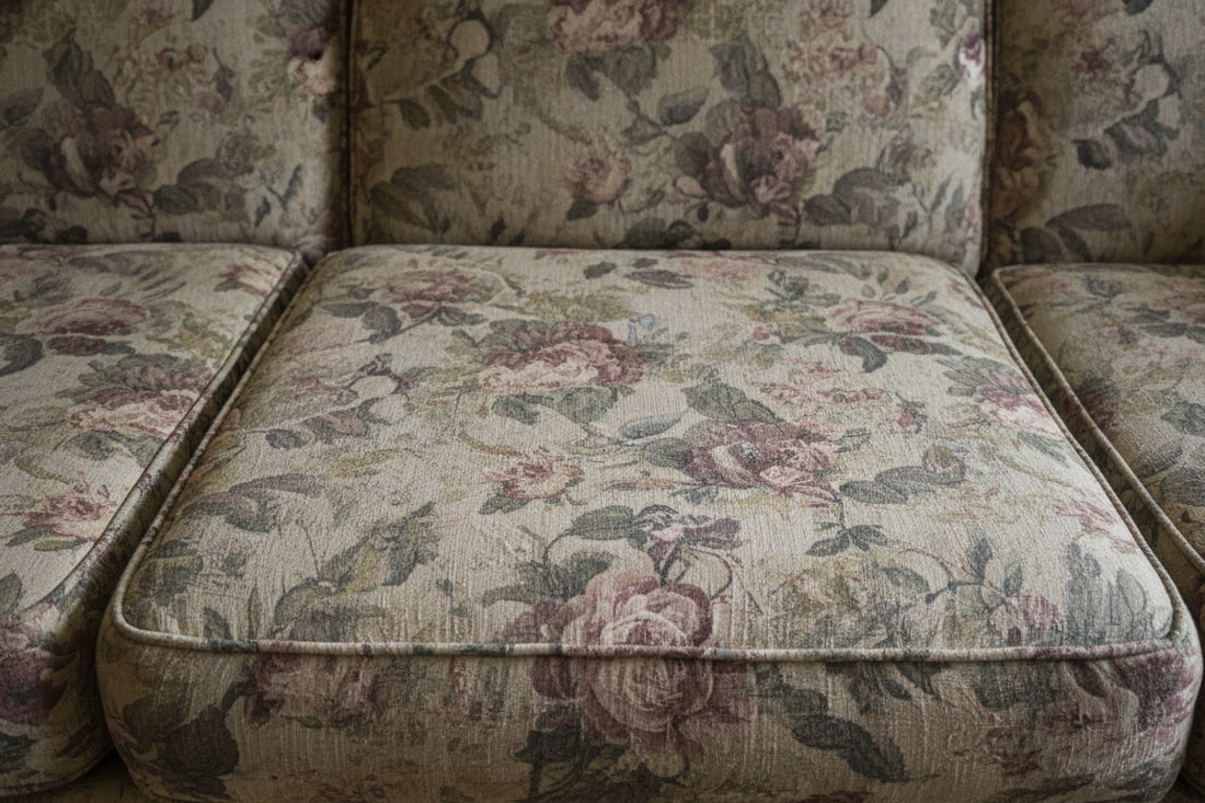 Worn sofa cushion showing compression and use