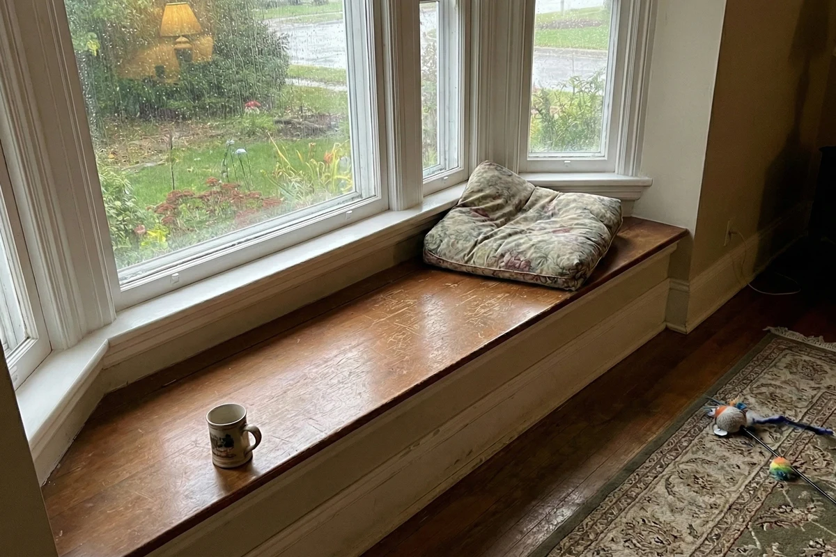 Bench or window seat without cushion in home photographed with phone camera